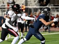 Flower Mound's Walker Mulkey (15) catches a touchdown pass in front of Coppell's Braxton...