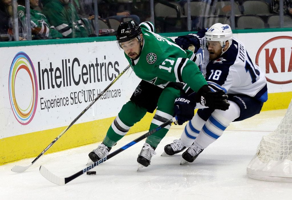 Dallas Stars center Devin Shore (17) attempts to gain control of the puck in front of...