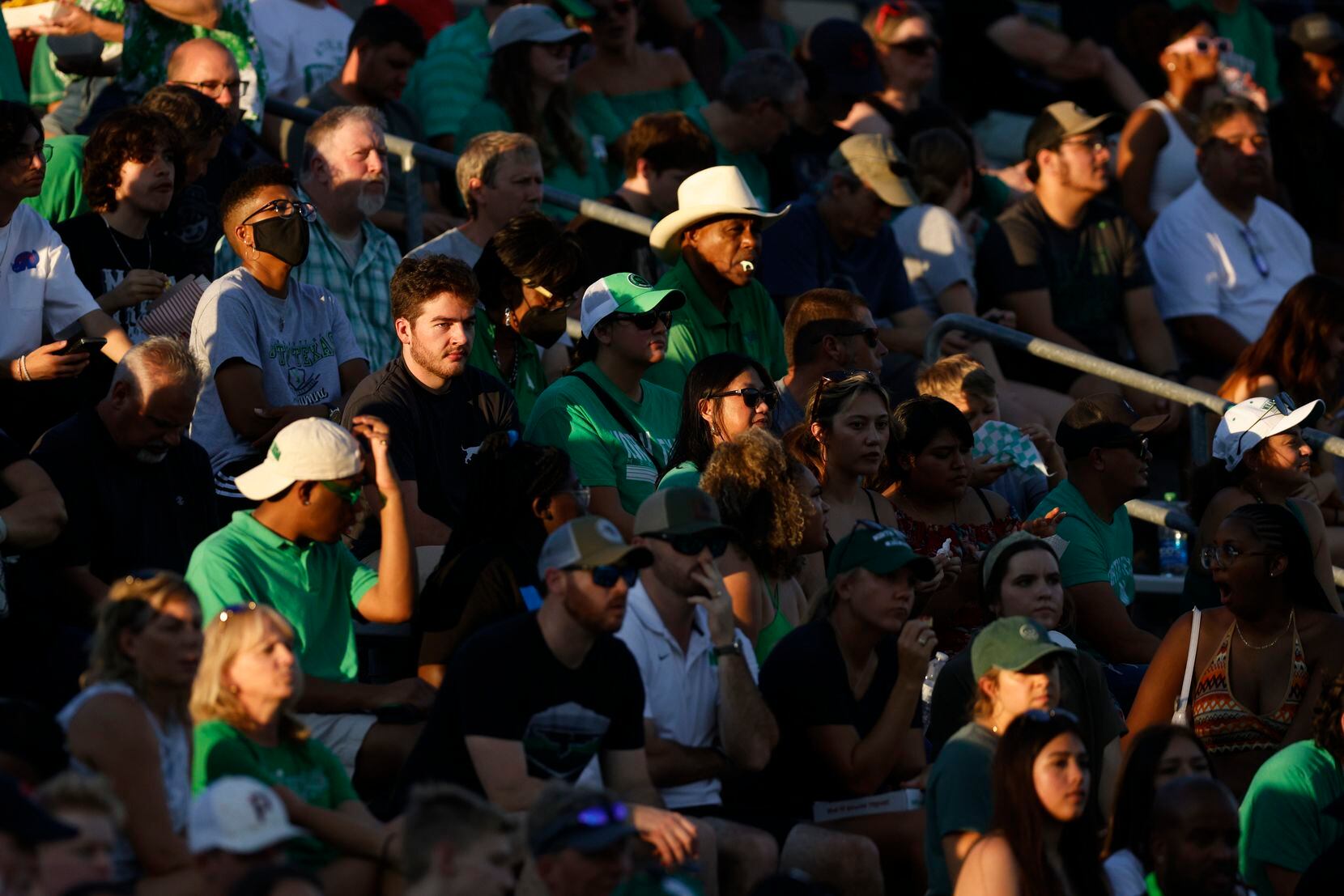 UNT fans sit in the sun during the first quarter of a game against SMU at Apogee Stadium in...