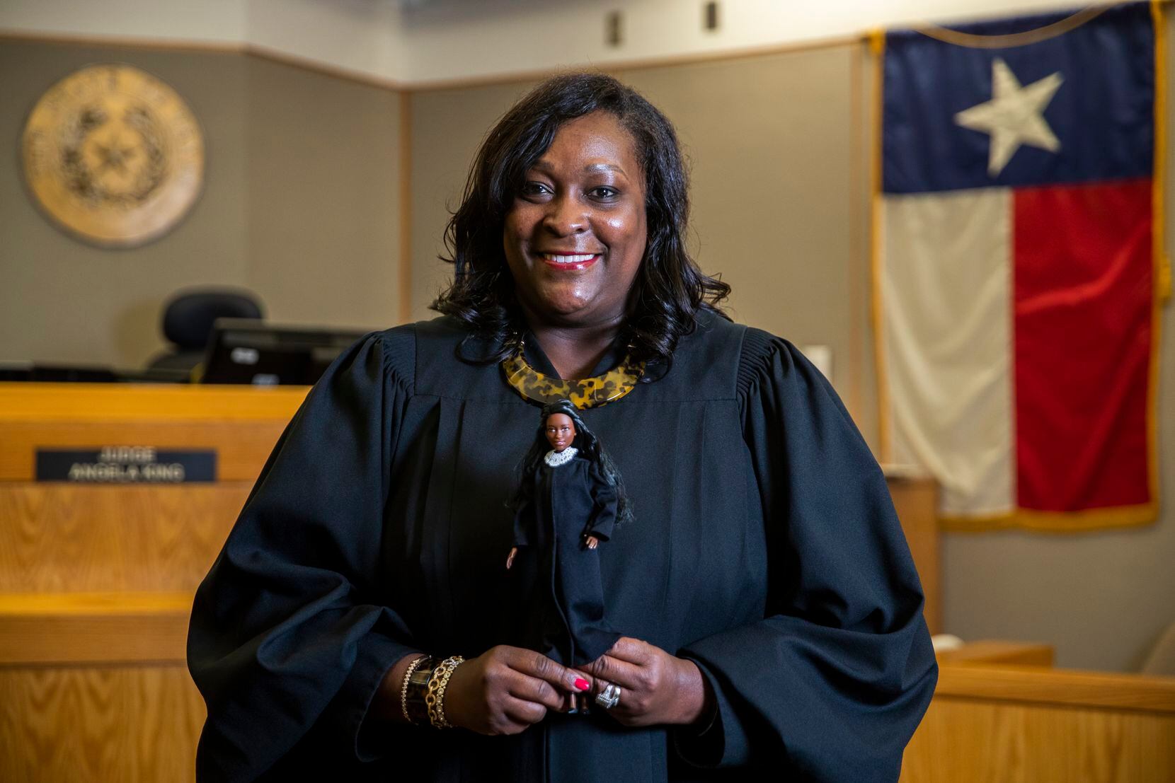 Dallas County Criminal Court Judge Angela King poses for a portrait with a Judge Barbie doll...