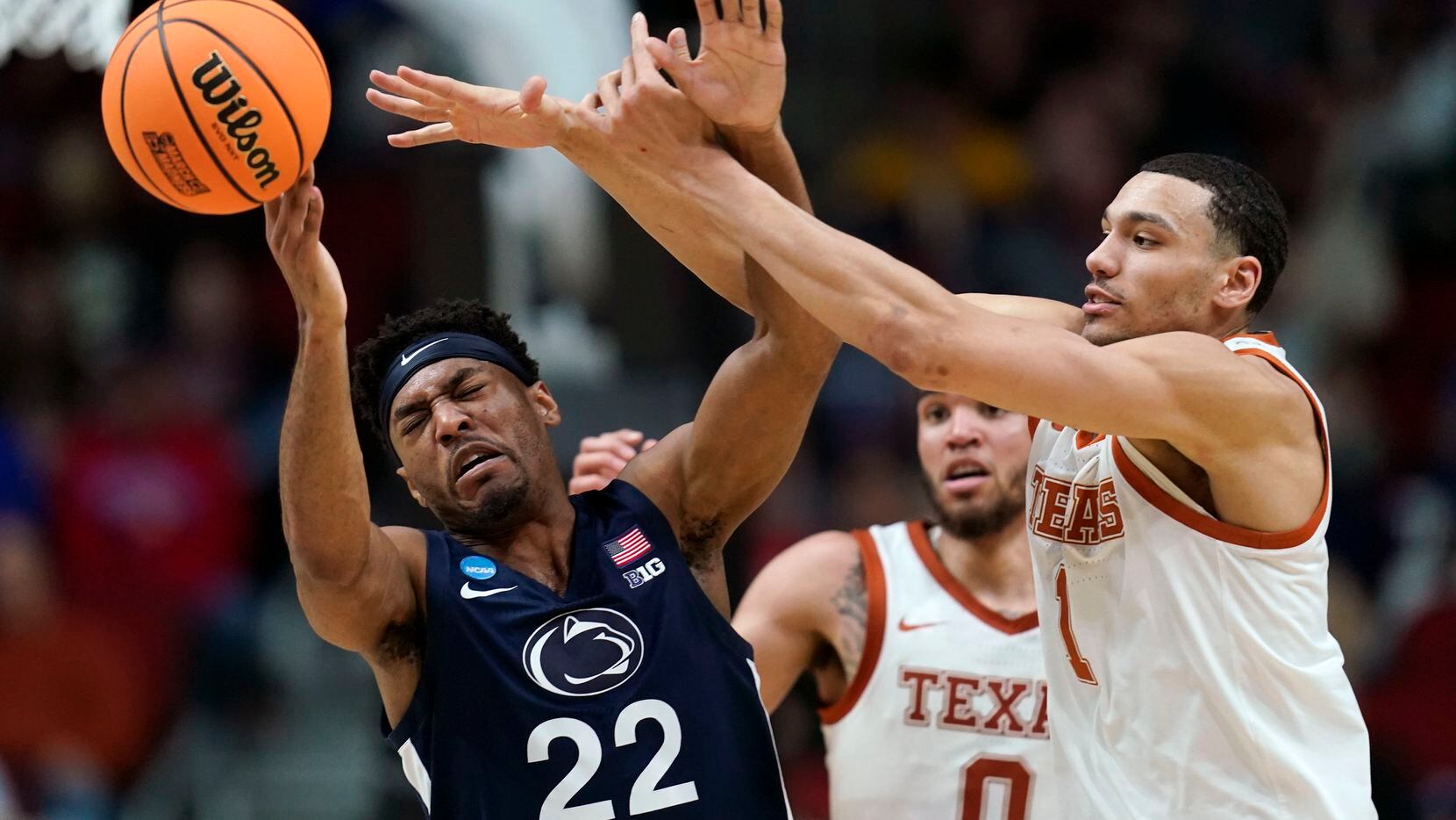 Penn State guard Jalen Pickett (22) is fouled by Texas forward Dylan Disu (1) in the first...