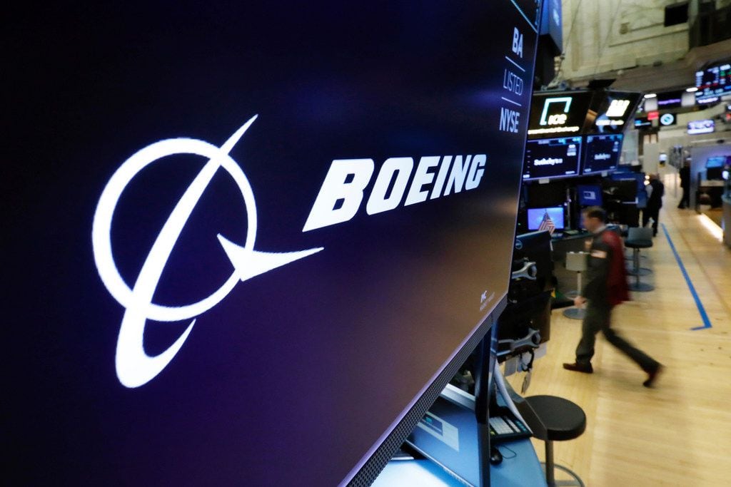 The Boeing logo appears above a trading post on the floor of the New York Stock Exchange...