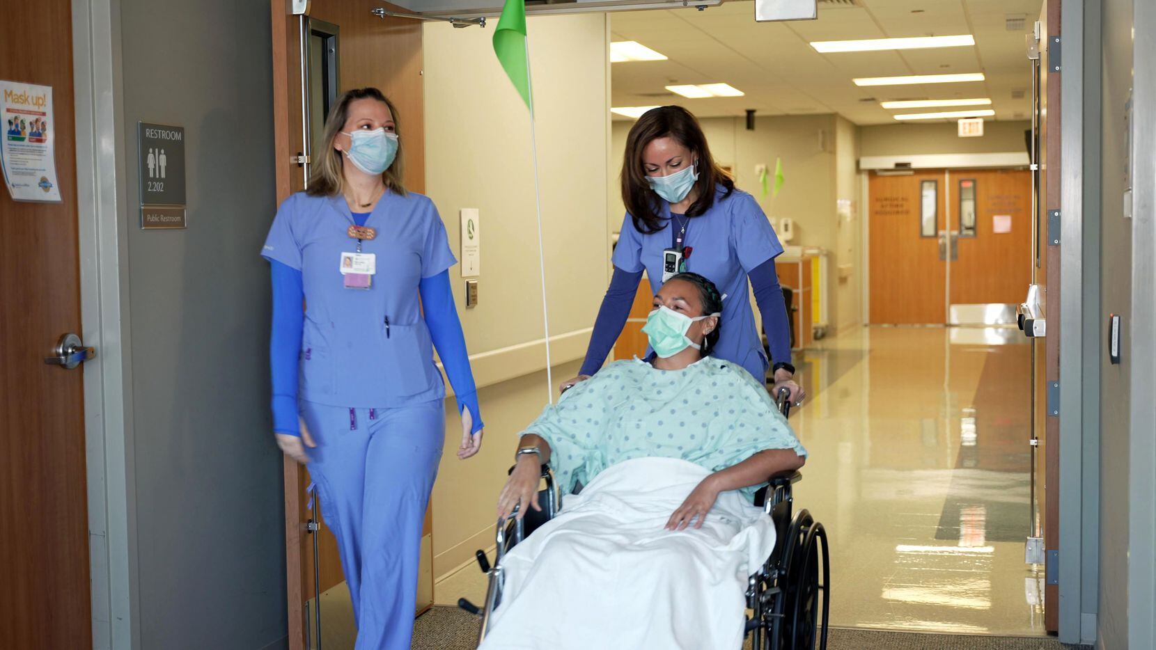 Nurses pushing patient in wheelchair