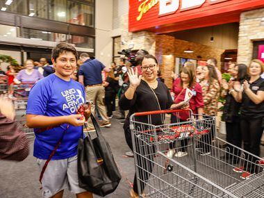 Dante and Claudia Tapia celebrate as they enter the new H-E-B.