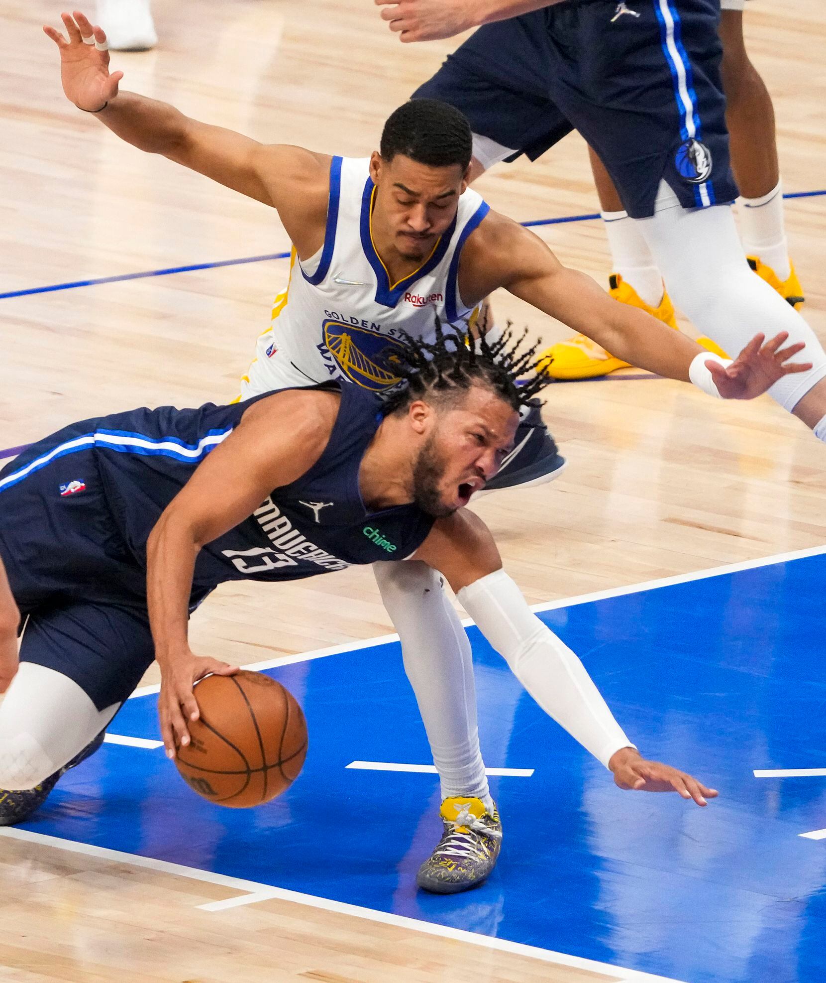 Dallas Mavericks guard Jalen Brunson (13) slips to the floor as Golden State Warriors guard...