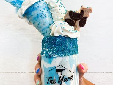 The Yard Milkshake Bar will sell the Texas Twister shake at its new store in The Colony. It's cookies and cream ice cream with blue sugar 'sand' and marshmallow drizzle. On top is a sugar cone filled with whipped cream, a cloud of cotton candy, and a cow made of chocolate.