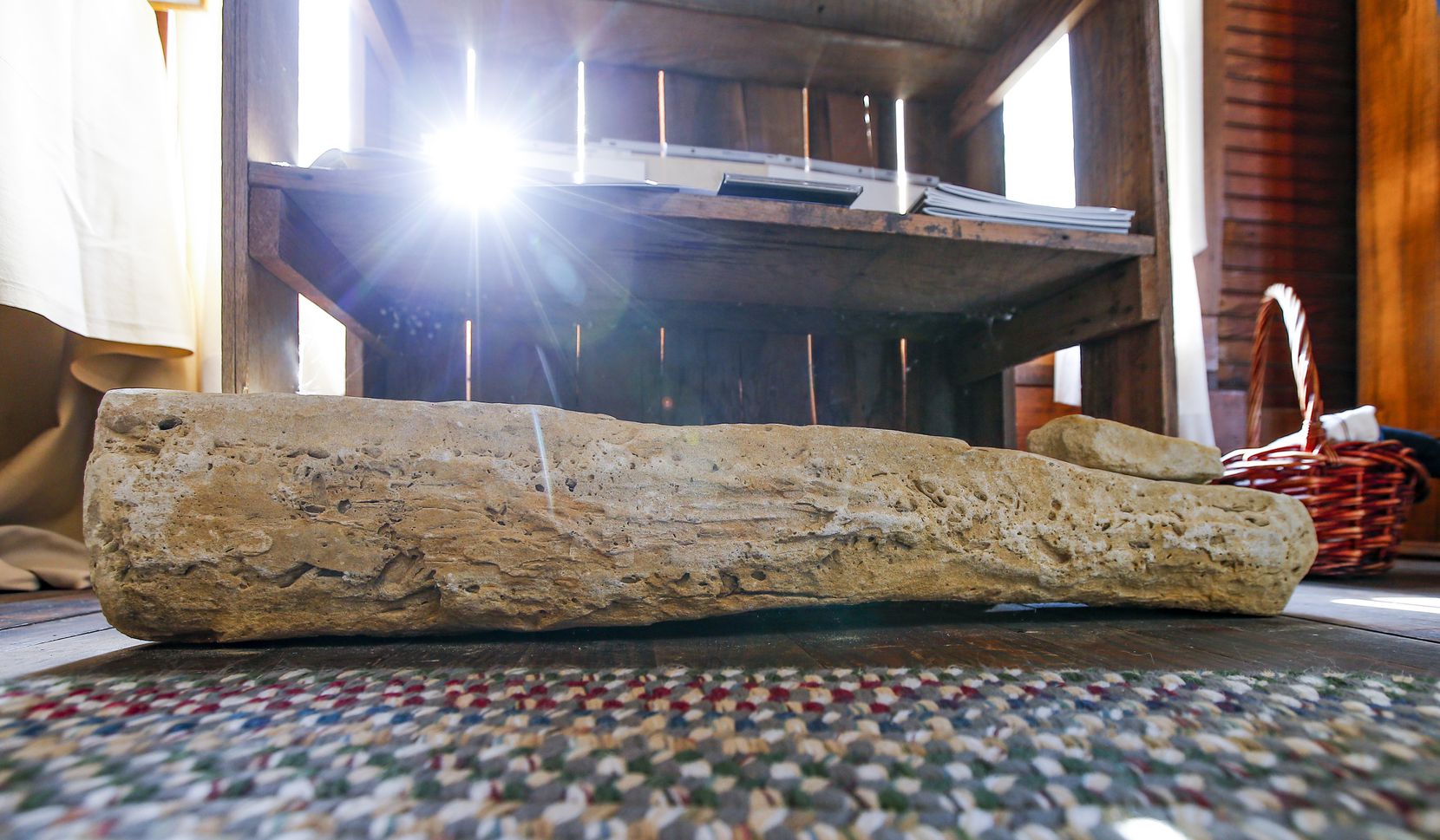 A piece of the Rock Wall lays on the floor at the Rockwall County Historical Foundation.