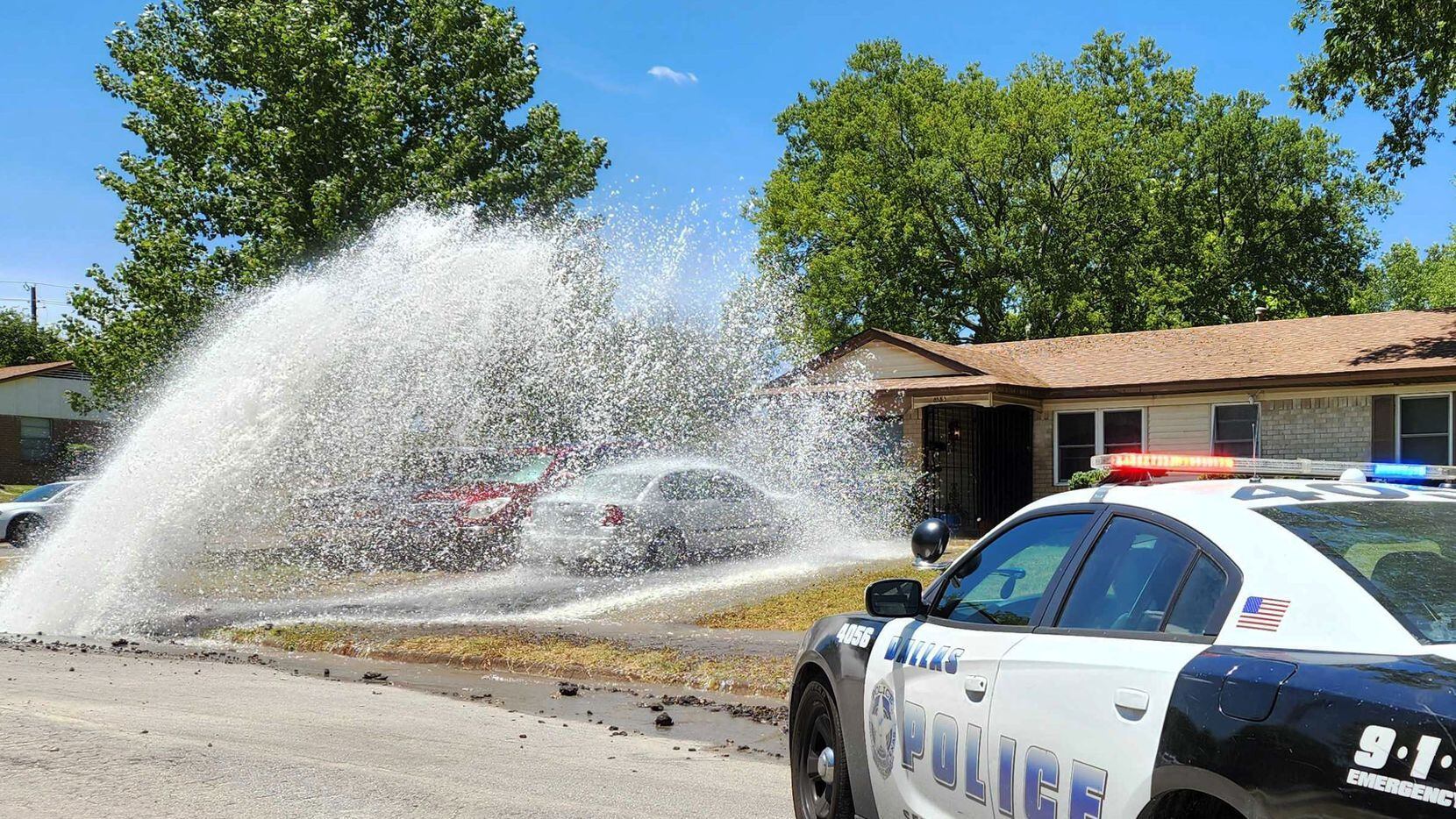 Water from a water main break shoots up into the sky and onto a southeast Oak Cliff home on...