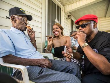 Richard Overton (left) smokes a cigar with neighborhood friends Donna Shorts (center) and...