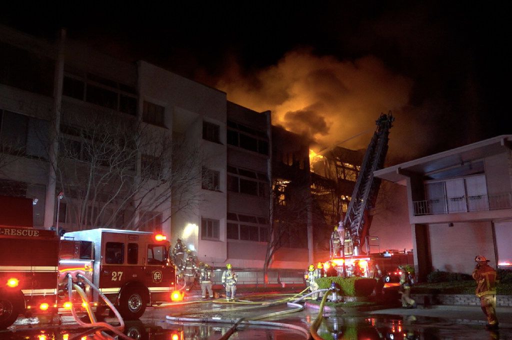 Dallas Fire-Rescue personnel fight a 7-alarm fire at the Preston Place condos in the 6200...