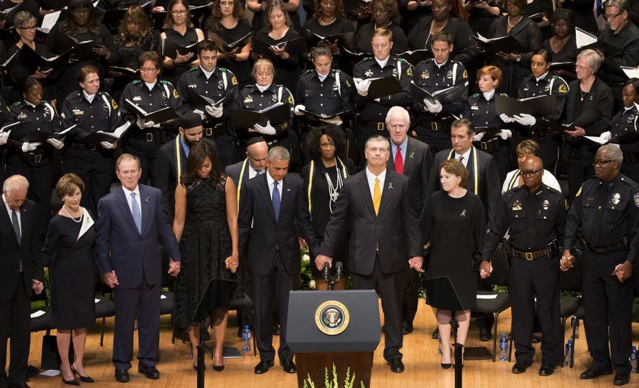 President Barack Obama joined hands with Mayor Mike Rawlings and other dignitaries during a...