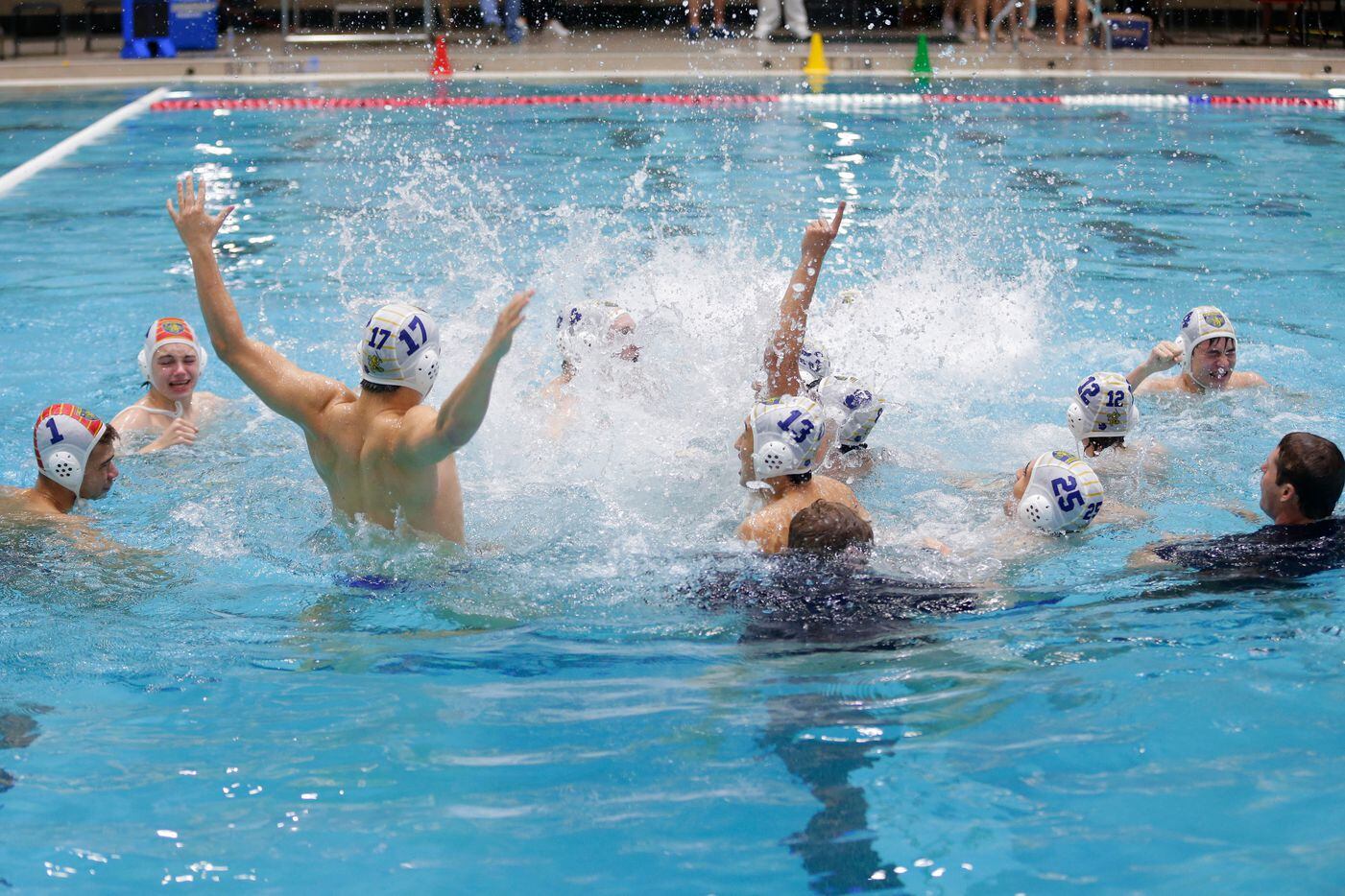 St. MarkÕs players and coaches splash in the pool to celebrate defeating Dawon to win the...