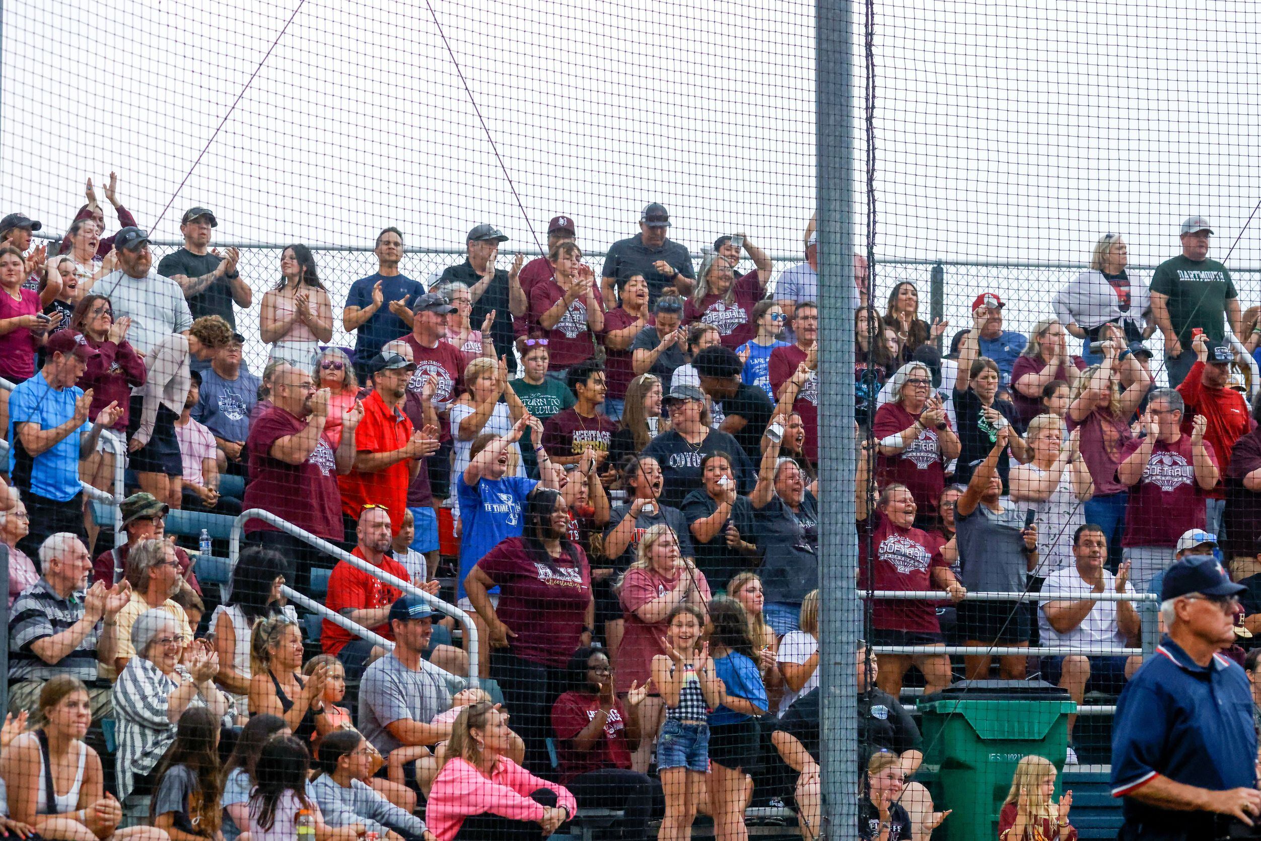 The crowd cheers as Frisco Heritage right fielder Maddy Garza (10) slides into home plate,...