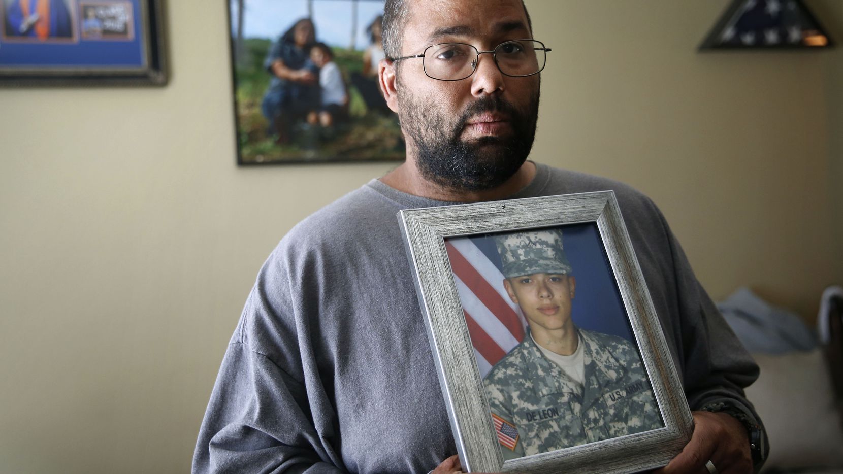 Ricky DeLeon holds a portrait of his son, Isaac Lee DeLeon, at his home in San Angelo on...