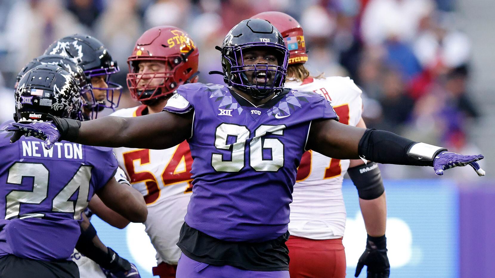 TCU Horned Frogs defensive lineman Lwal Uguak (96) celebrates a first half stop of the Iowa...