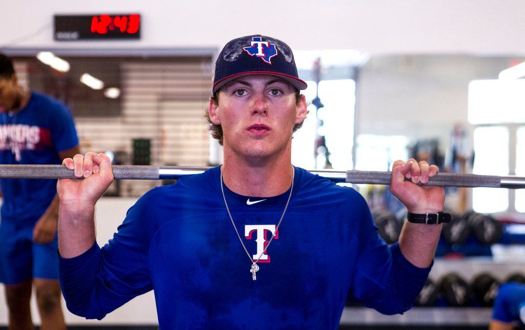 Texas Rangers' pitcher Mason Englert does squats at the Rangers' training facility Thursday,...