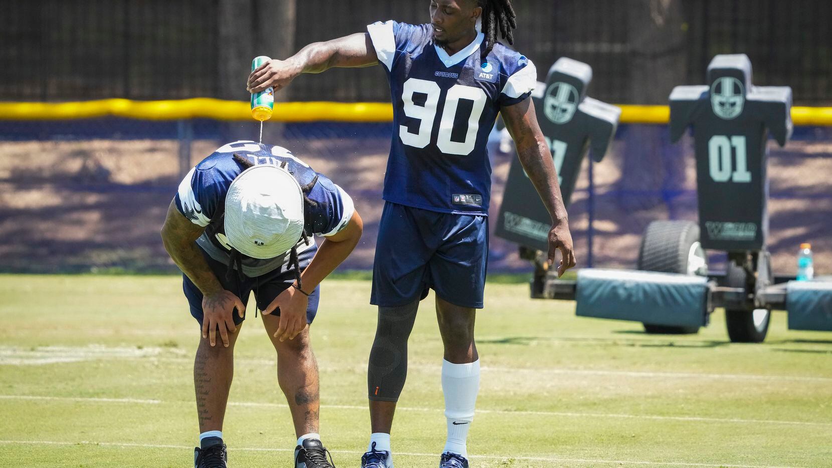 Dallas Cowboys defensive end DeMarcus Lawrence (90) pours water on defensive tackle Trysten...