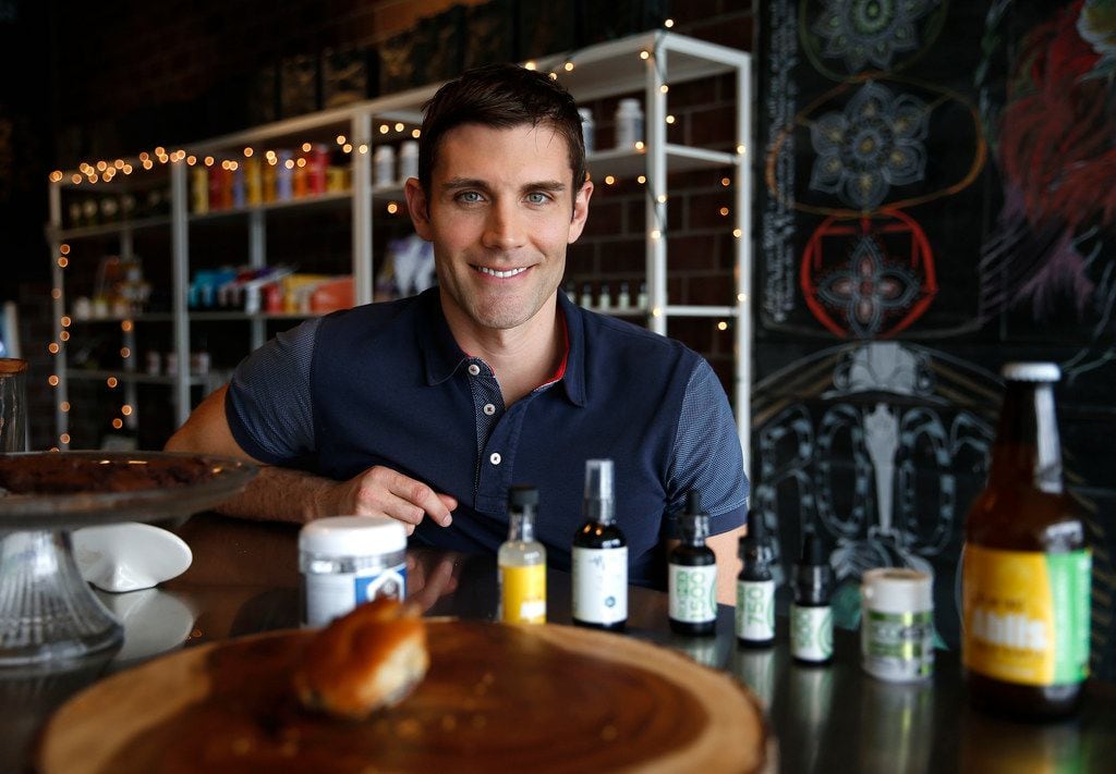 Roots Juices owner Brent Rodgers poses with some of the products he sells at shops in Oak...