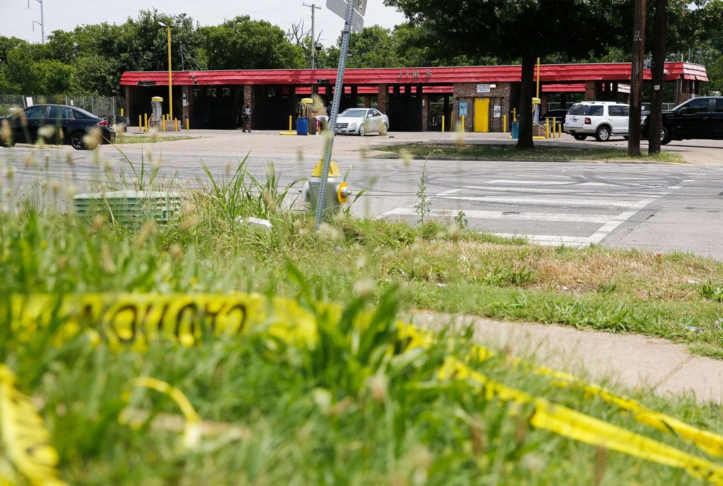 Caution tape lay across the street from Jim's Car Wash in Dallas on June 3, 2019. Four...