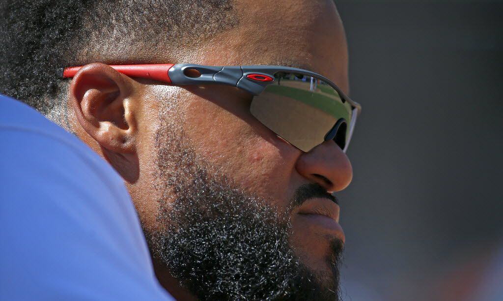 Texas Rangers' Prince Fielder watches the game at the end of the 8th inning against Seattle...
