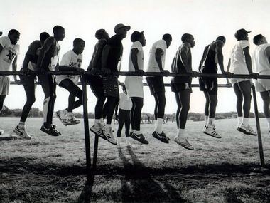 Carter players practiced calisthenics on the parallel bars. (File Photo/Staff) 