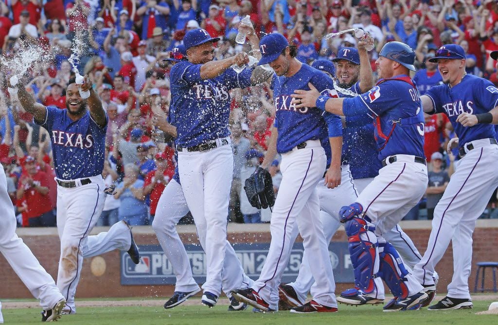 Texas Rangers starting pitcher Cole Hamels (35) is mobbed by teammates after pitching a...