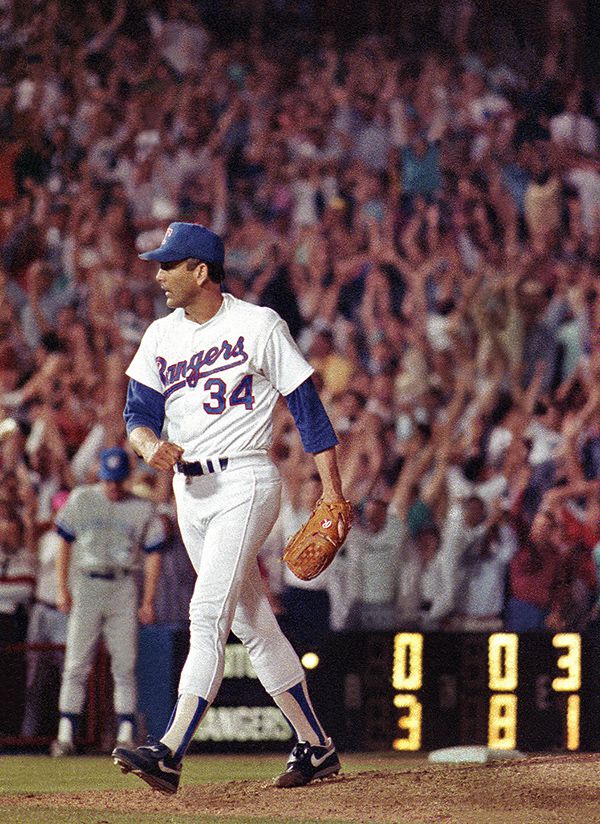 May 1, 1991--As the crowd goes wild in the stands behind him, Texas Rangers pitcher Nolan...