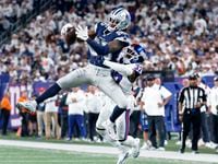 Dallas Cowboys wide receiver Noah Brown (85) goes high over New York Giants cornerback...