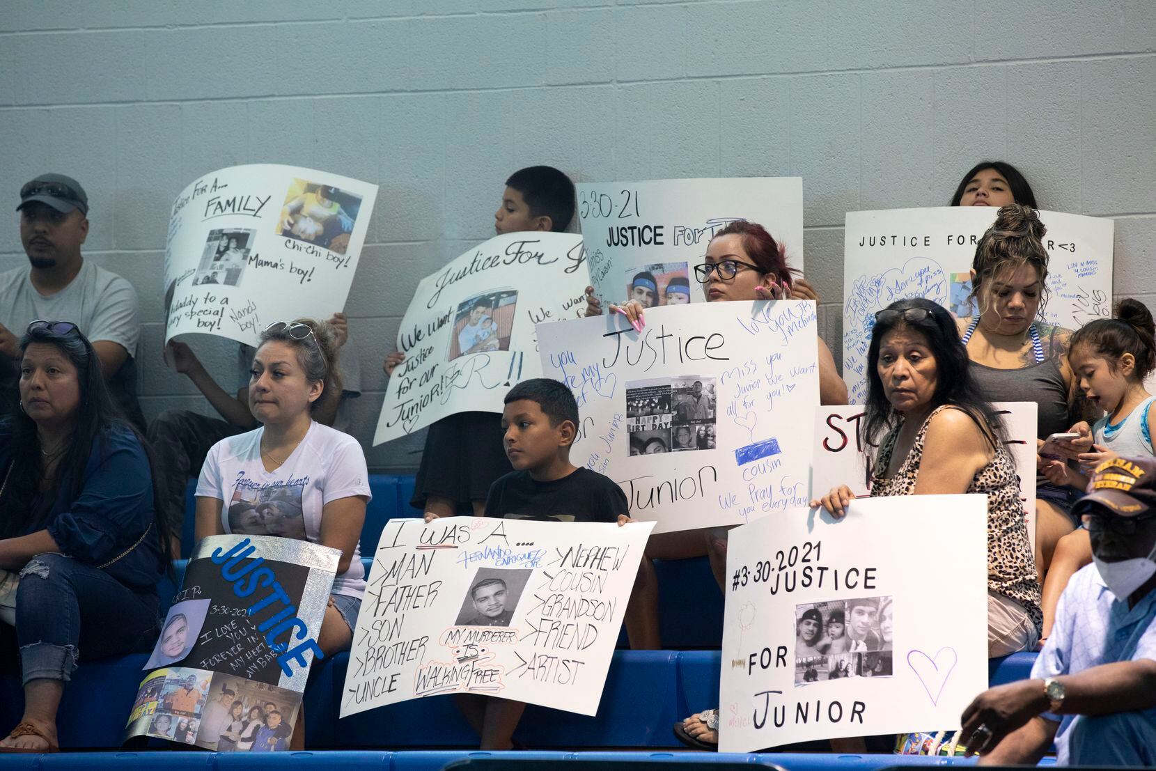 A large group of relatives and supporters held signs seeking justice for Fernando Enriquez Jr.