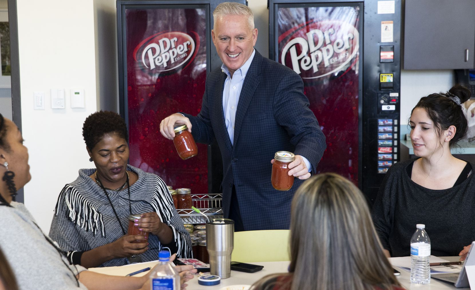 President and CEO Lynn Davis passes out jars of his homemade salsa at Dallas Children's...