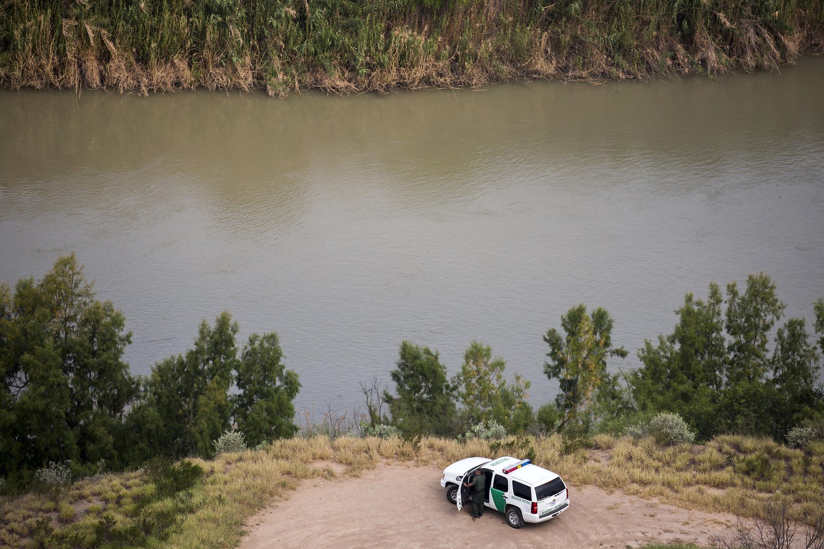 A U.S. Customs and Border Protection officer watches over the Rio Grande River on Wednesday,...