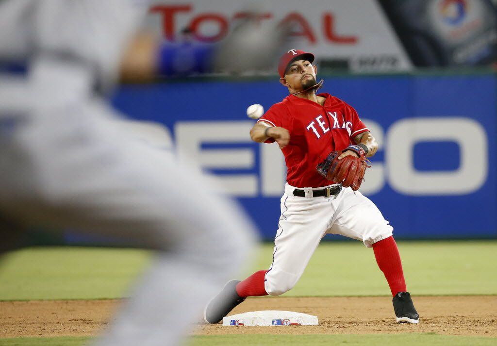 Texas Rangers second baseman Rougned Odor completes a double play during the 5th inning...