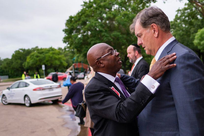 Dallas Mayor Mike Rawlings talks with council member Tennell Atkins after an offsite City...