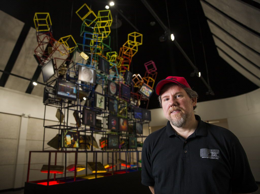 Museum Director Joe Santulli poses for a portrait in the lobby of the National Videogame Museum next to a video game inspired sculpture designed by Jeremy Zvitt (not pictured) on Thursday, October 8, 2015 in Frisco, Texas.
