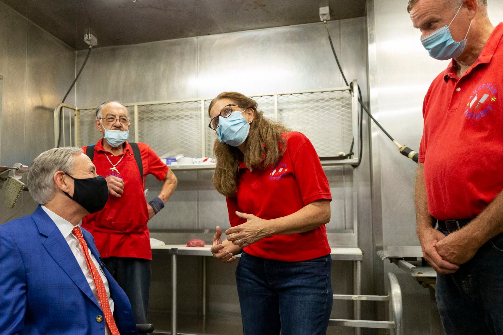 Gov. Greg Abbott (left) tours American Butchers with co-owners Desiree Wineland (center) and Calvin Wineland (right) at the Dallas Farmers Market on Friday.