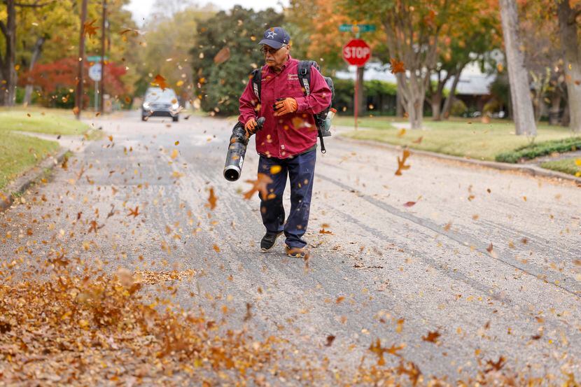 A yard worker cleared leaves from the street in front of an East Dallas property in 2021....