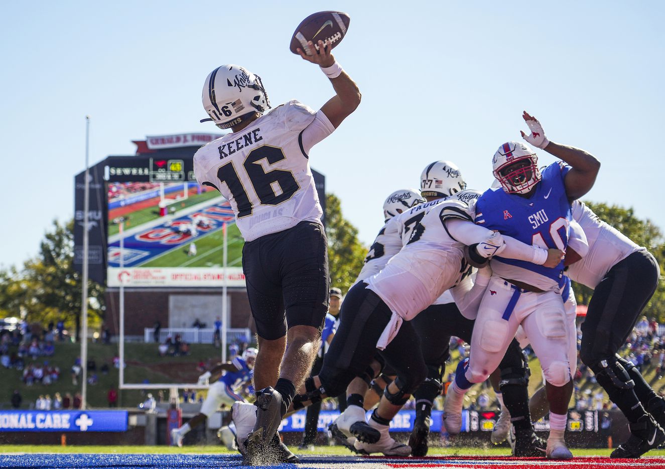 UCF quarterback Mikey Keene (16) throws a pass from his own end zone as SMU defensive tackle...