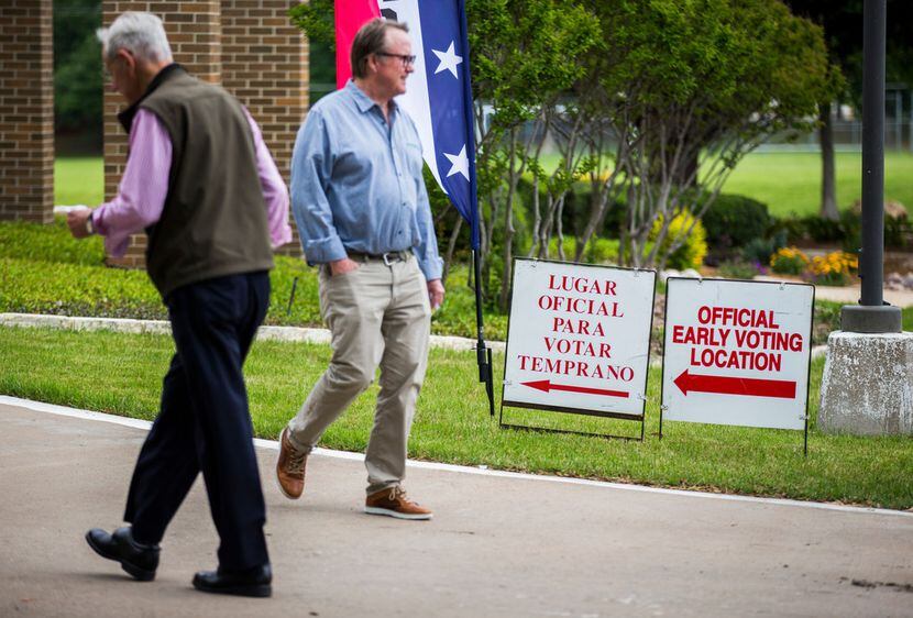 Early voters arrive at and exit Our Redeemer Lutheran Church, an early voting polling place,...