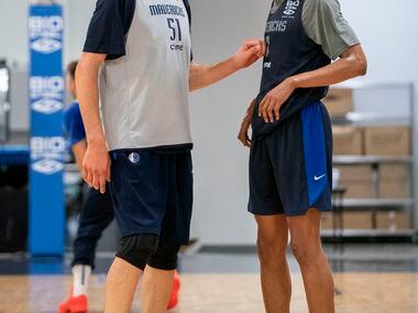 Dallas Mavericks centers Boban Marjanović (51) and Moses Brown (9) pause to talk during a...