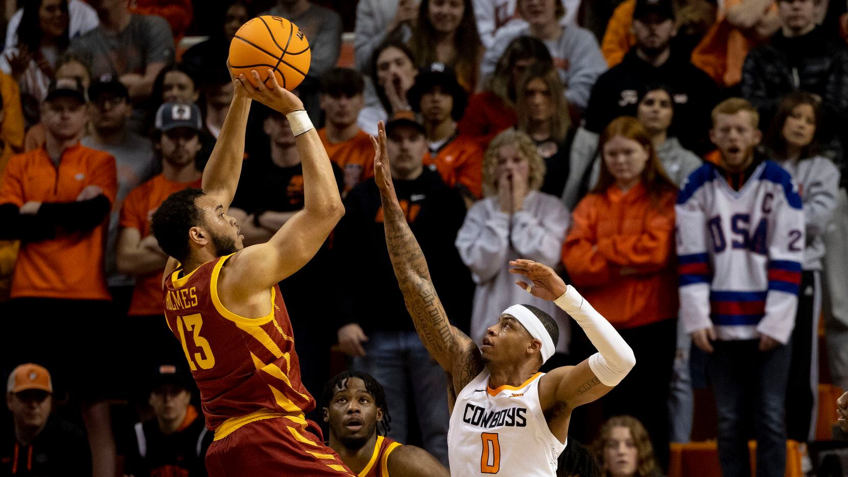 Iowa State's Jaren Holmes (13) shoots over Oklahoma State's Avery Anderson III (0) in the...