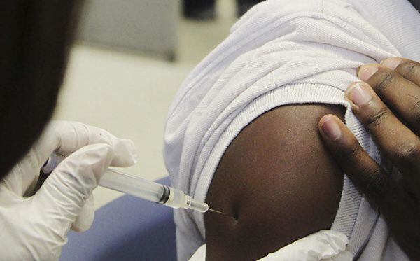 Tyrin Manchester, 12, received a vaccine at the Dallas County Health and Human Services'...