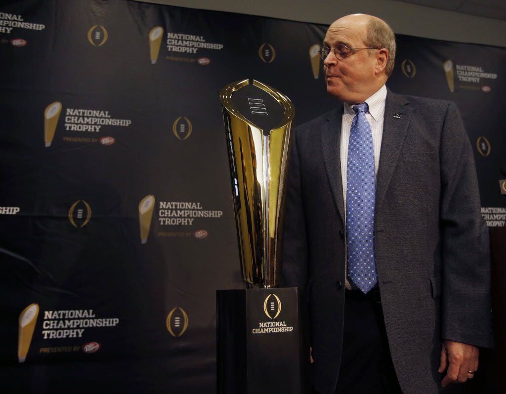 College Football Playoff executive director Bill Hancock poses with the new national...