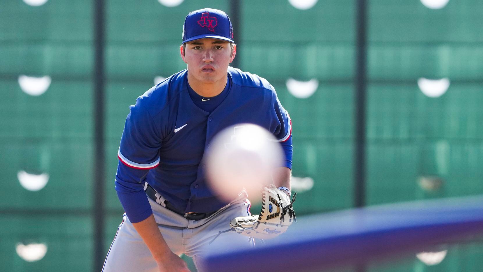 Pitcher Owen White participates in a drill during a Texas Rangers minor league spring camp...