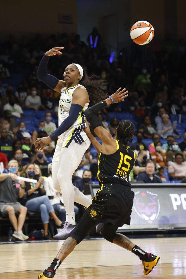 Dallas Wings guard Arike Ogunbowale (24) makes an assist in front of Los Angeles Sparks guard Brittney Sykes (15) during the second half of a WNBA basketball game in Arlington, Texas on Sunday, Sept. 19, 2021. (Michael Ainsworth/Special Contributor)