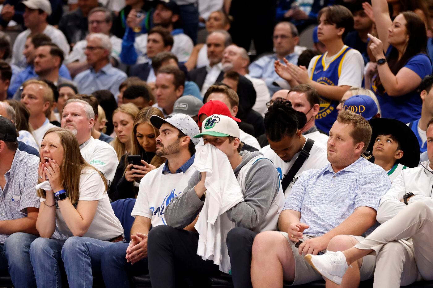 Dallas Mavericks fans watch nervously as the Golden State Warriors close the lead during the...