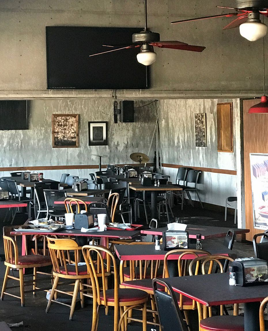 After a fire in the kitchen of Smokey John's, the dining room looks untouched except for...
