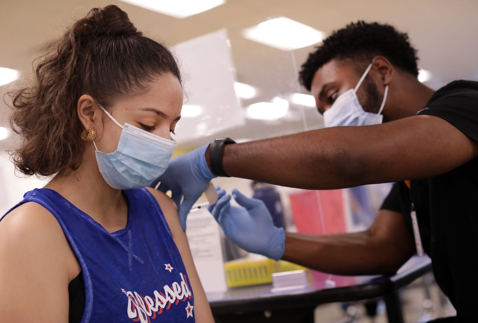16-year-old Emilia Carreno received a COVID-19 vaccination shot from Kendall Payne during a pop-up clinic put on by Dallas ISD and Parkland Memorial Hospital at Samuell High School on June 28. Health officials say that people who are not vaccinated for COVID-19 are at particular risk of contracting one of the disease's emerging variants.