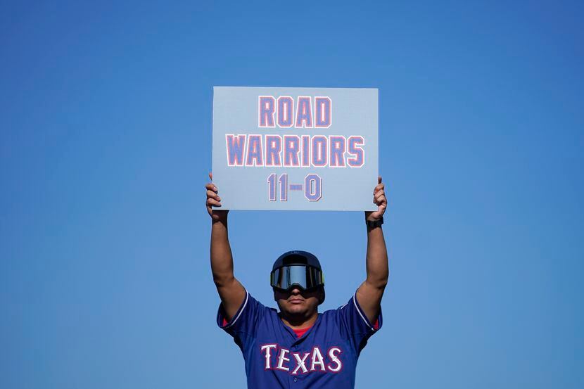 Una fan de los Texas Rangers con un cartel que hace referencia a las 11 victorias sin...