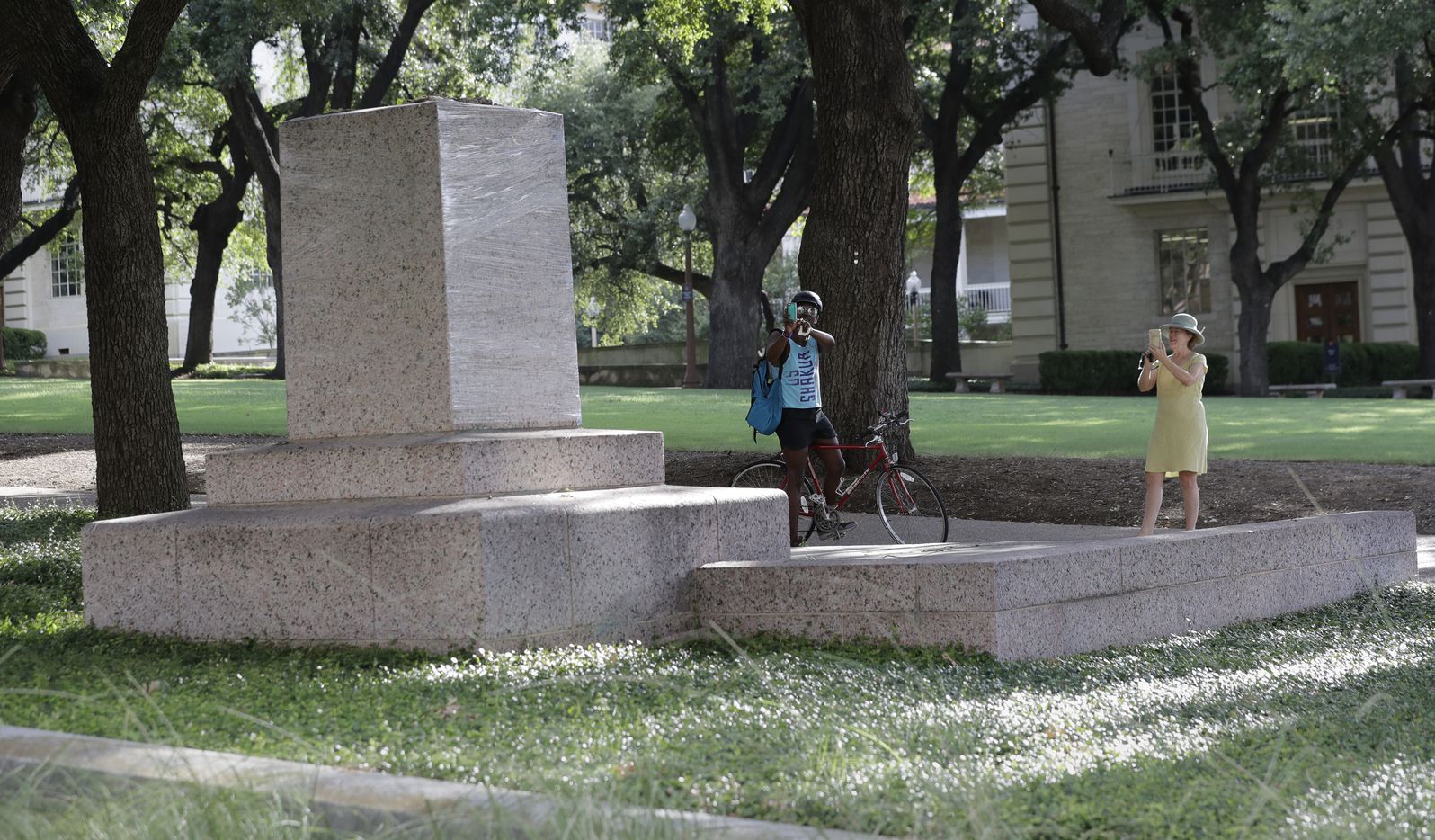 A pedestal wrapped in plastic that had held a statue of Confederate Gen. Robert E. Lee,...