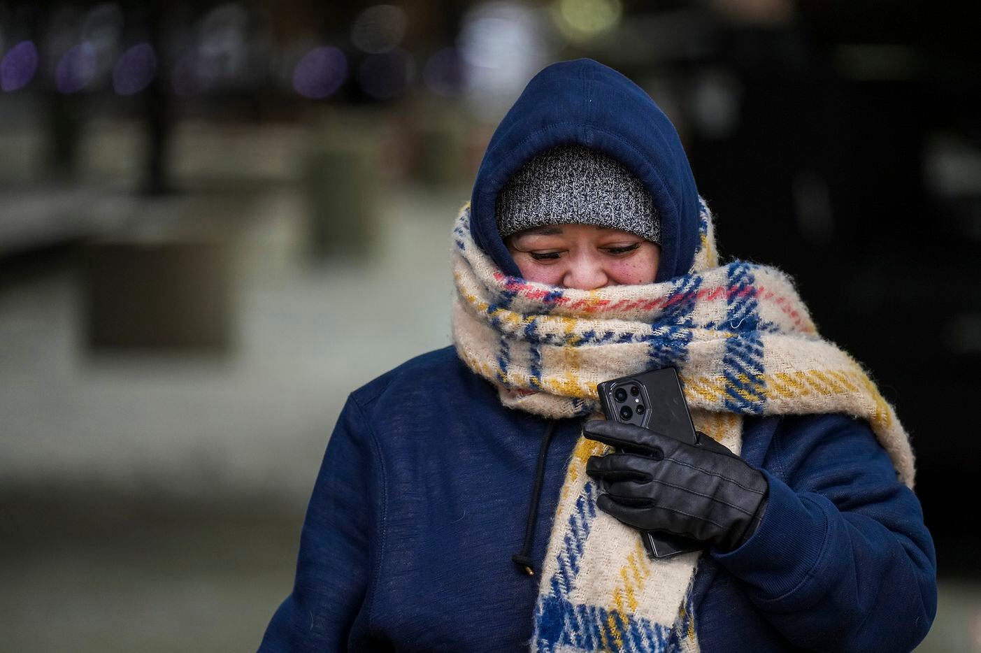 Camelia Rojas bundles up against the cold as she walks from the parking lot into Buc-ee's on...